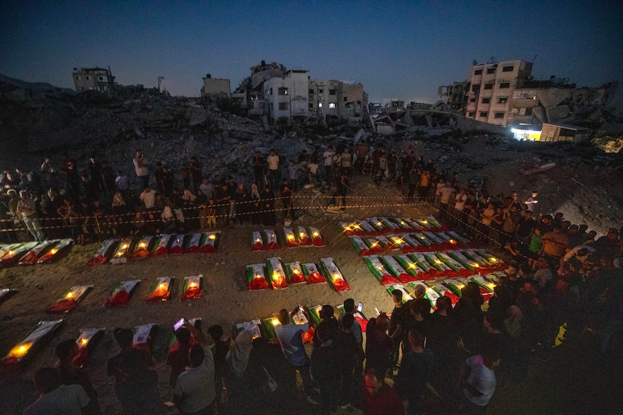 I partecipanti al funerale accendono candele durante una cerimonia funebre collettiva e una veglia in memoria di 105 palestinesi, vicino alle macerie dell’edificio Al Tajj nella città di Gaza, nella Striscia di Gaza, il 30 settembre 2026. La Protezione Civile di Gaza ha recuperato i resti da sotto le macerie del complesso residenziale Al Tajj, distrutto durante i raid aerei israeliani nell’ottobre 2023. Le vittime, tra cui donne e bambini, sono rimaste intrappolate sotto le macerie per quasi tre anni prima di essere recuperate e sepolte. EPA/MOHAMMED SABER (EPA)