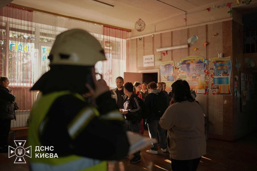 A rescuer helps students evacuate from a shelter of a damaged school which was hit by a Russian jet-drone strike, amid Russia's attack on Ukraine, in Kyiv, Ukraine October 1, 2026. Press service of the State Emergency Service of Ukraine in Kyiv/Handout via REUTERS THIS IMAGE HAS BEEN SUPPLIED BY A THIRD PARTY. DO NOT OBSCURE LOGO. (via REUTERS)