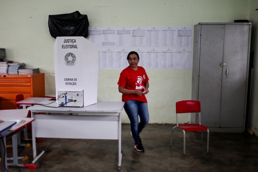 Una donna che indossa una maglietta a sostegno del presidente brasiliano e candidato alla rielezione del Partito dei Lavoratori (PT), Luiz Inácio Lula da Silva, vota durante le elezioni generali brasiliane in un seggio elettorale situato in una scuola a Vila Estrutural, alla periferia di Brasilia, in Brasile. (REUTERS)