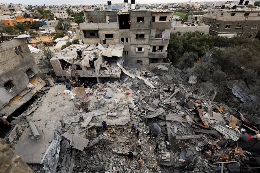 I palestinesi ispezionano il luogo in cui sorgeva un'abitazione colpita dai raid aerei israeliani, dopo che sabato in tarda serata l'esercito israeliano aveva intimato ai residenti di evacuare la zona, ad Al-Zawayda, nella Striscia di Gaza centrale, l'11 ottobre 2026. REUTERS/Mahmoud Issa (REUTERS)