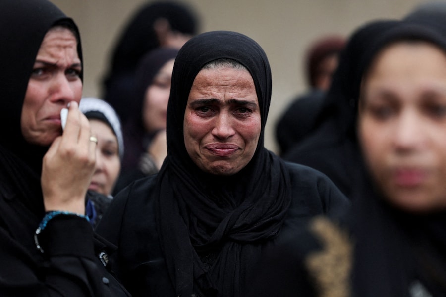 I partecipanti al funerale piangono durante la cerimonia funebre di Azza Ramzy, una hostess egiziana di 28 anni rimasta uccisa nell’attacco all’aeroporto di Riyadh, nel suo villaggio natale di Al-Atf, nel distretto di El Mahmoudia, nel governatorato di Beheira, a nord del Cairo, in Egitto (REUTERS)