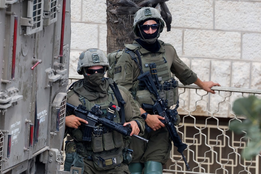Soldati israeliani prendono posizione durante un raid a Ramallah, nella Cisgiordania occupata da Israele (REUTERS)