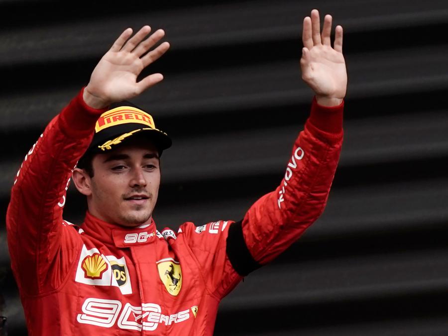 Winner Ferrari's Monegasque driver Charles Leclerc waves to the public as he arrives to celebrate on the podium after the Belgian Formula One Grand Prix at the Spa-Francorchamps circuit in Spa on September 1, 2019. (Photo by Kenzo TRIBOUILLARD / AFP)