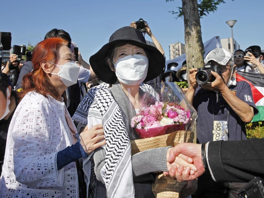 Fusako Shigenobu, al centro, che ha co-fondato il gruppo terroristico Japanese Red Army, stringe la mano a un sostenitore dopo essere uscita dal carcere di Akishima, sobborgo di Tokyo. (Kyodo News via AP)