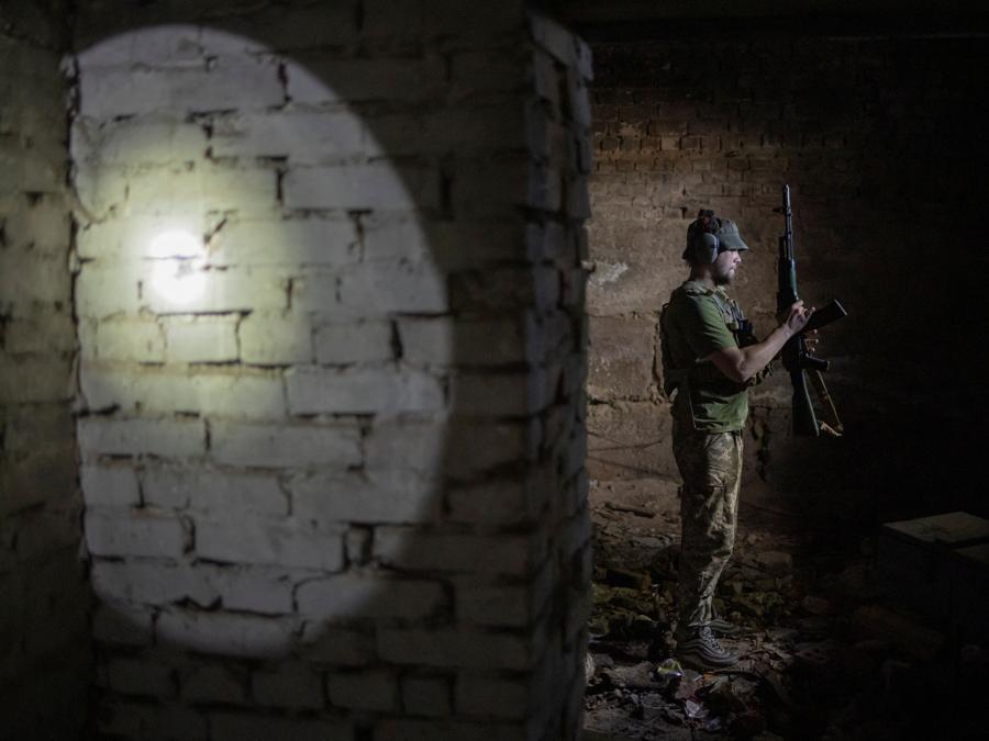 Un membro del battaglione dei Carpazi Sich, controlla la sua arma nella base operativa avanzata del gruppo in un bunker sotterraneo, in prima linea nella regione di Kharkiv. REUTERS/Marko Djurica