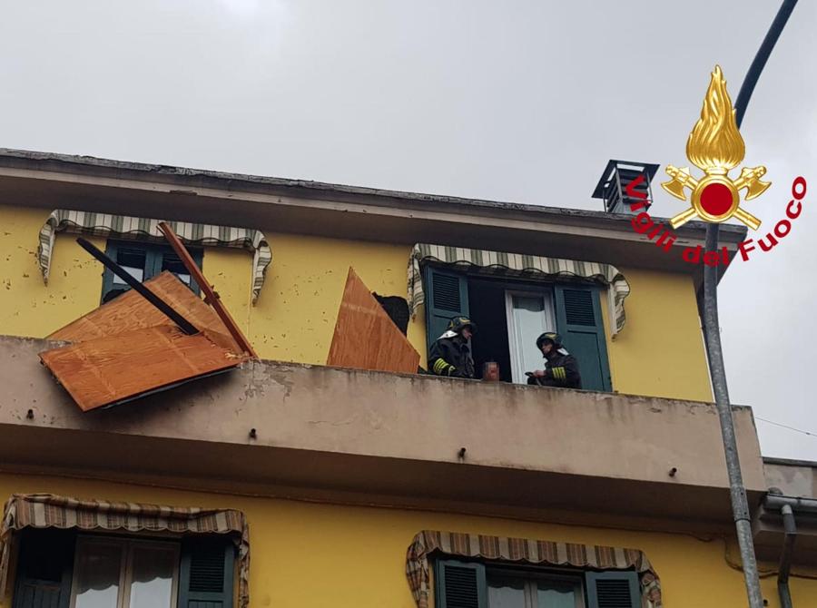 I vigili del fuoco intervengono per rimuovere un tetto volato via da una abitazione che ha centrato un auto a Fornaci di Barga (Lucca). ANSA/VIGILI DEL FUOCO