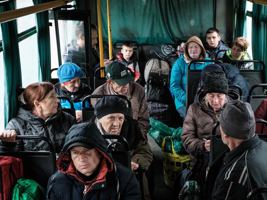 Un gruppo di persone della città di Kupiansk attendono su un autobus per evacuare a Shevchenkove, nella regione di Kharkiv. (Photo by Yasuyoshi Chiba / AFP)
