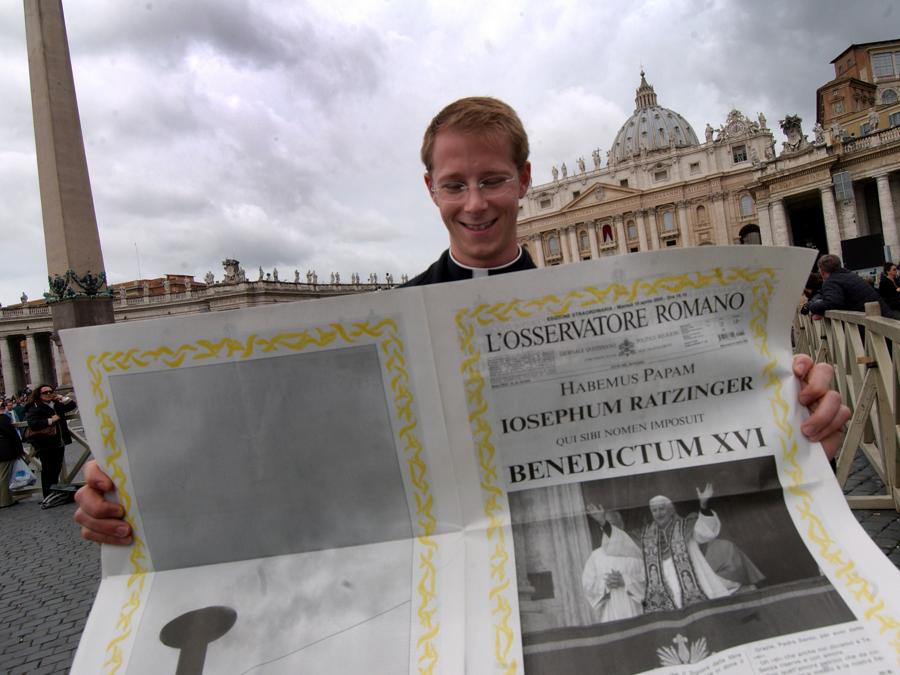 Un giovane ecclesiastico legge un’edizione speciale dell’Osservatore Romano  che annuncia l’elezione di Papa Benedetto XVI (’Habemus Papam’) in Piazza San Pietro in Vaticano il 19 aprile 2005. (Reuters/Foto di Eric Vandeville/Abacapress.com)