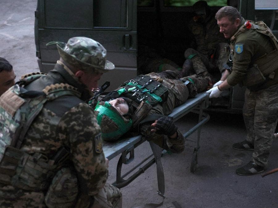 Soldati trasportano un ferito in un punto di stabilizzazione nel Donetsk. (AFP)