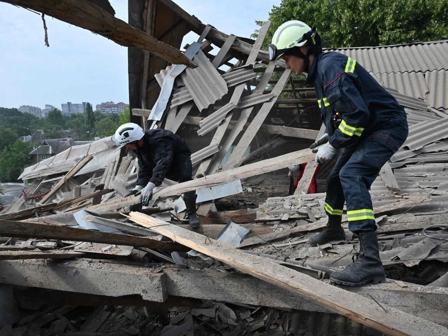 I soccorritori rimuovono i detriti dopo che un drone ha colpito un istituto scolastico, a Kharkiv. (Photo by Sergey Bobok / Afp)