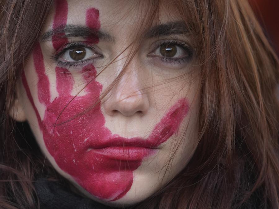 Una donna partecipa a una manifestazione in occasione della Giornata internazionale per l’eliminazione della violenza contro le donne, a Milano, Italia, sabato 25 novembre 2023. (AP Photo/Luca Bruno)