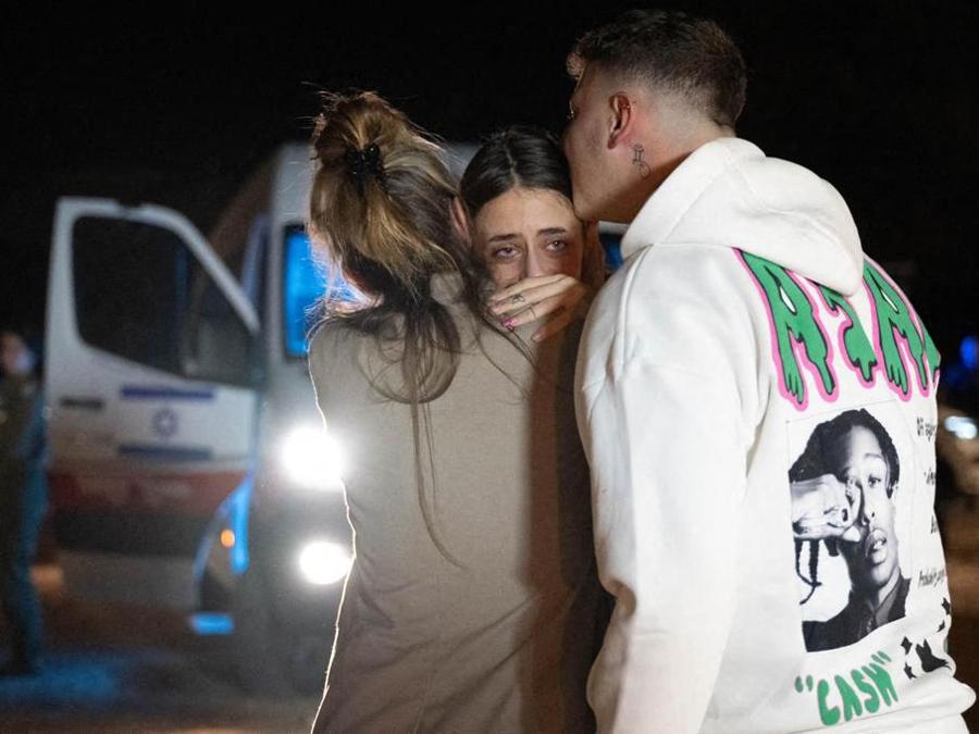 L’ex ostaggio franco-israeliano Mia Shem con sua madre e suo fratello all’arrivo alla base aerea di Hatzerim dopo il suo rilascio da parte del gruppo palestinese Hama. (Photo by GPO / AFP) 
