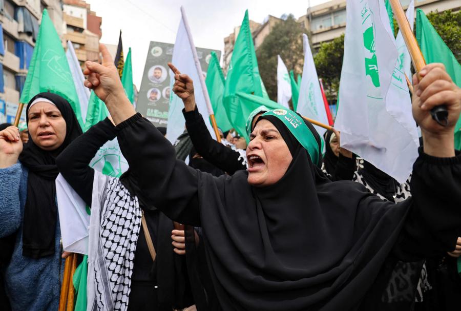 Alcune donne urlano slogan durante il corteo funebre dei funzionari di Hamas. (Photo by Anwar Amro / AFP)