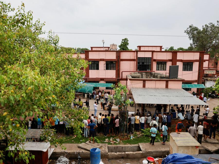 Persone si radunano fuori da un ospedale dove sono state trasferite le vittime di una fuga precipitosa, nel distretto di Hathras, nello stato settentrionale dell’Uttar Pradesh. (REUTERS/Anushree Fadnavis)