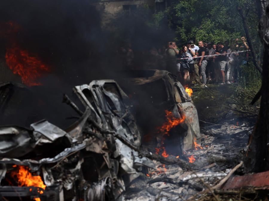 Auto in fiamme sul luogo di un attacco missilistico a Kiev. (Photo by Anatolii Stepanov / AFP)