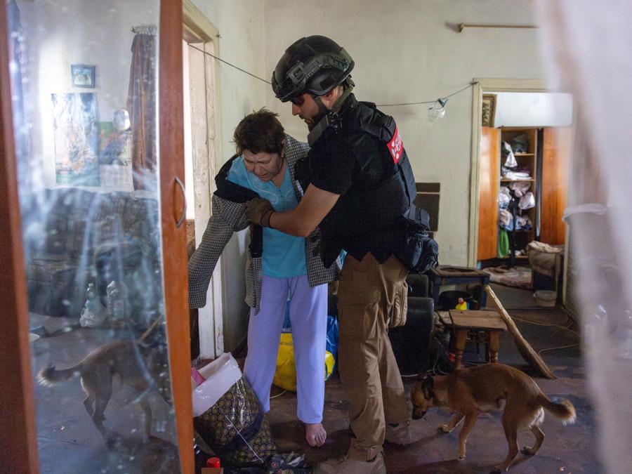Un volontario di East SOS assiste un residente che sta fuggendo da casa a causa dell’avanzata russa, nel mezzo dell’attacco russo all’Ucraina, a Selydove vicino a Pokrovsk, Ucraina. REUTERS/Thomas Peter