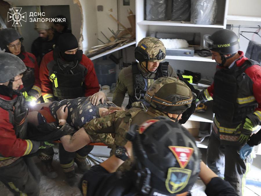 I soccorritori evacuano un residente di un condominio dopo che la Russia ha attaccato la città con bombe guidate durante la notte a Zaporizhzhia, Ucraina. (Ukrainian Emergency Service via AP)