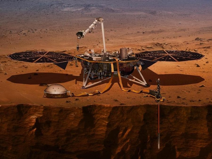 Un’illustrazione mostra il lander InSight che sta perforando la superficie di Marte. (NASA via AP)
