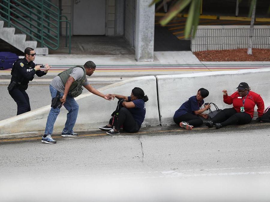 Persone al riparo, polizia che controlla. (Joe Raedle/Getty Images/AFP)