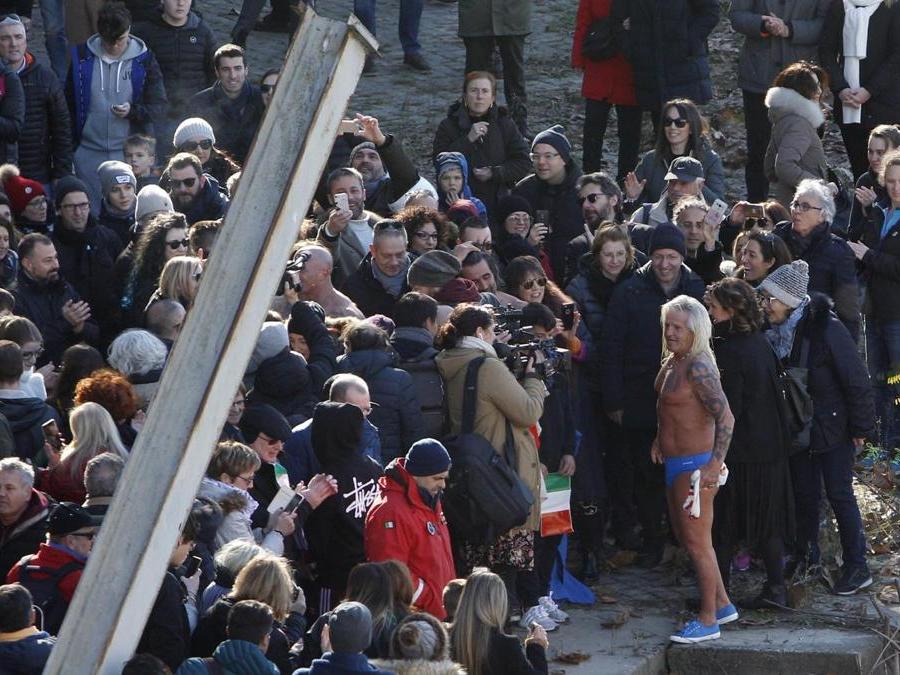 Maurizio Palmulli, d'Italia, saluta i fan dopo essersi tuffato nel fiume Tevere Maurizio. (AP Photo/Riccardo De Luca)