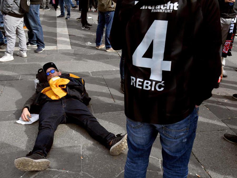 Un tifoso dellì’Eintracht Frankfurt dorme disteso sulla piazza del Duomo (Ansa/Daniel Dal Zennaro)