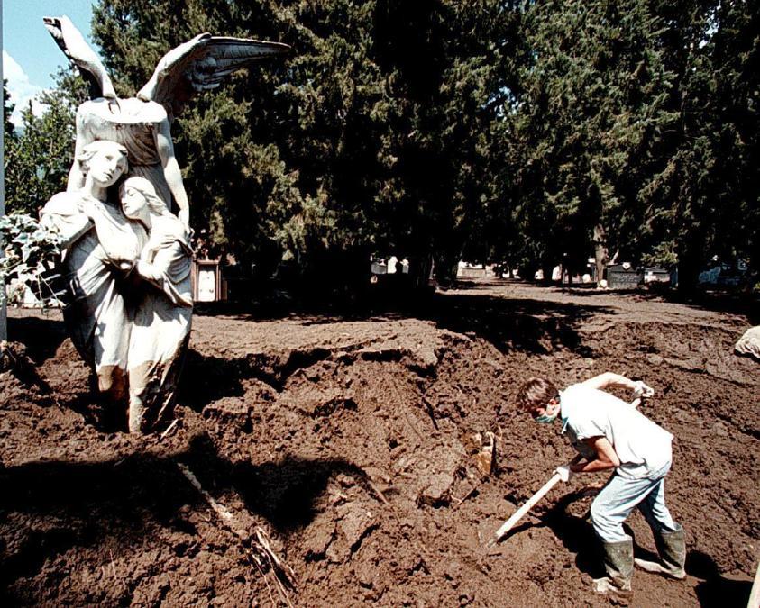 A forza di braccia si cerca di liberare dal fango il cimitero di Sarno investito dalla frana. (Ciro Fusco)