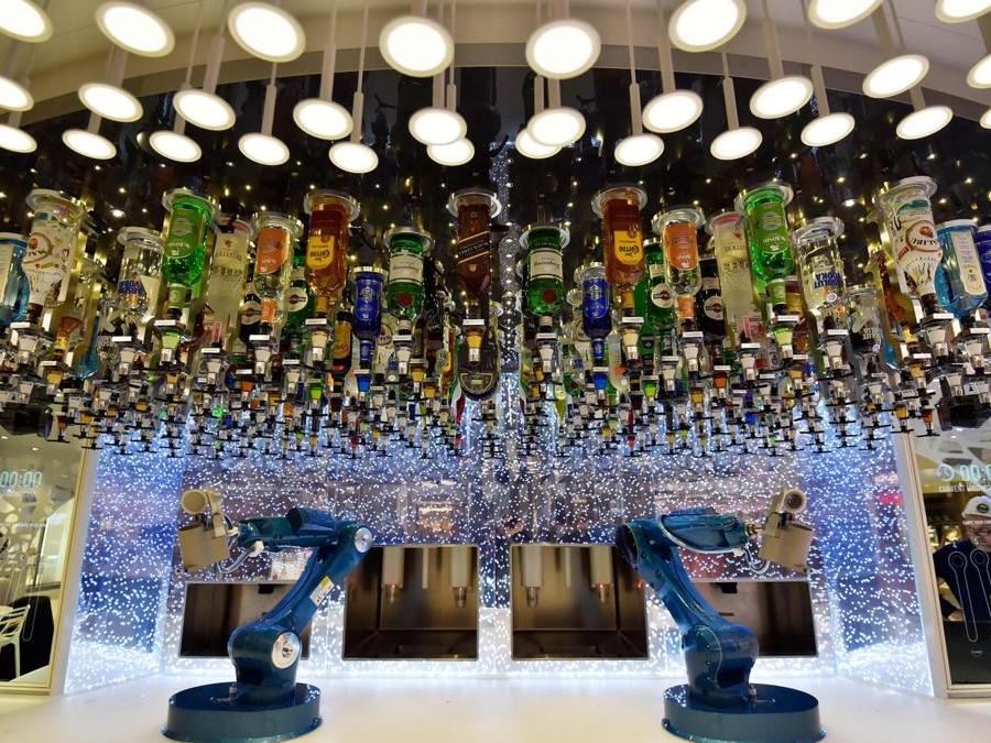 Robotic Bartenders are pictured onboard the US company Royal Caribbean Cruise Limited (RCCL) tourism cruise liner 'Symphony of the Seas' at the shipyard of Saint-Nazaire, western France, on March 23, 2018, the day before it leaves the STX shipyards. / AFP PHOTO / LOIC VENANCE
