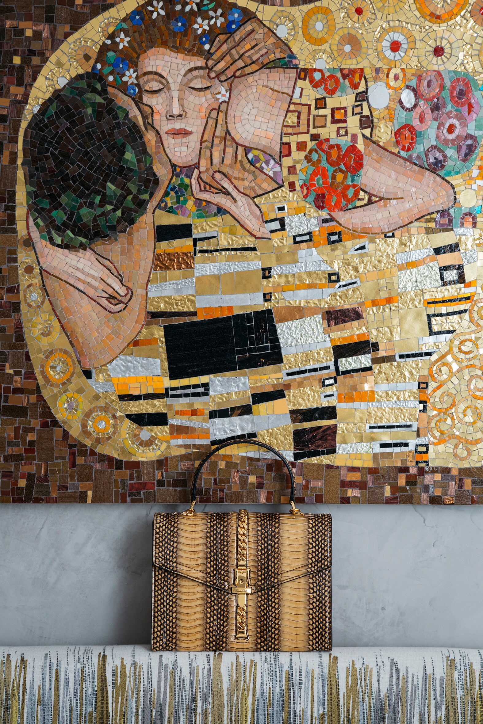 Mosaico di Tiziano Cortelli, nella stanza 302. Sulla testiera del letto, borsa Sylvie 1969, in pelle di serpente con chiusura-décor a catena e tracolla amovibile, Gucci.