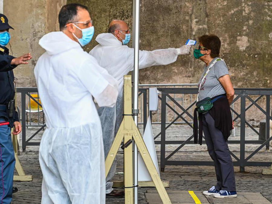 Controllo della temperatura per accedere alla Basilica di San Pietro , in Vaticano (Photo by Vincenzo Pinto / AFP)
