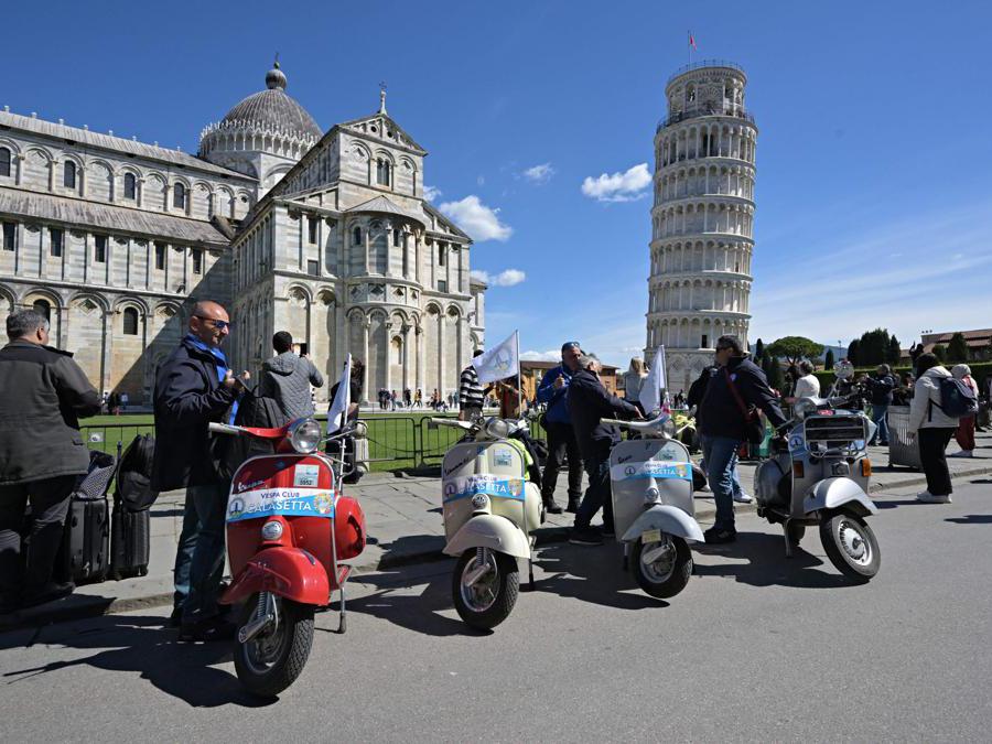 Vespa scooters are parked in front of Pisa Tower at Piazza dei Miracoli, during the Vespa World Days , in Pisa, Tuscany, on April 19, 2024. About 8.000 Vespa fans from 54 countries are expected in Pontedera for the international Vespa World Days from April 18, 2024 to April 21. (Photo by Andreas SOLARO / AFP)
