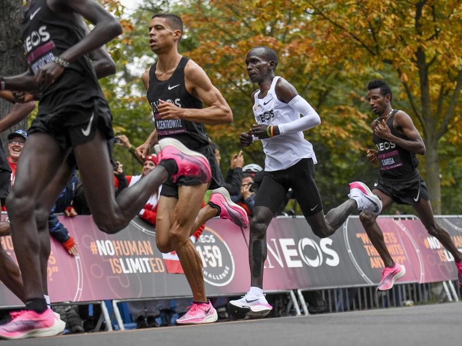 In this photo made available by The INEOS 1:59 Challenge on Saturday, Oct. 12, 2019, Eliud Kipchoge, white vest, and his team of pacemakers run along the Prater Hauptallee in Vienna, Austria. Saturday, Oct. 12, 2019, during his attempt to run a sub two-hour marathon.(Thomas Lovelock/The INEOS 1:59 Challenge via AP)