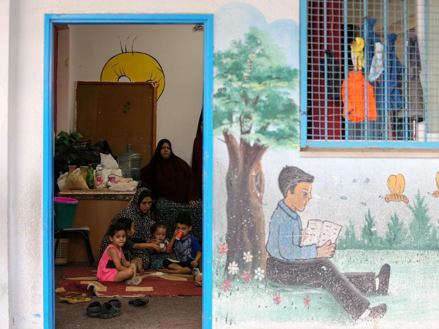 Palestinians, who fled their homes due to Israeli air and artillery strikes, sit in a classroom in a United Nations-run school where they take refuge, in Gaza City May 15, 2021. REUTERS/Ibraheem Abu Mustafa