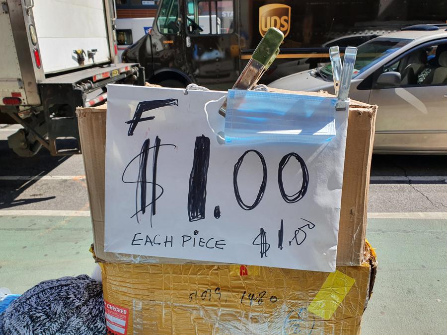 Sulla 6Th Avenue una bancarella improvvisata vende mascherine a un dollaro.