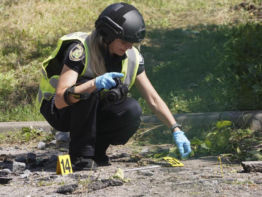 Kharkiv, un poliziotto ucraino esamina un sito colpito da un missile russo (EPA/VASILIY ZHLOBSKY)