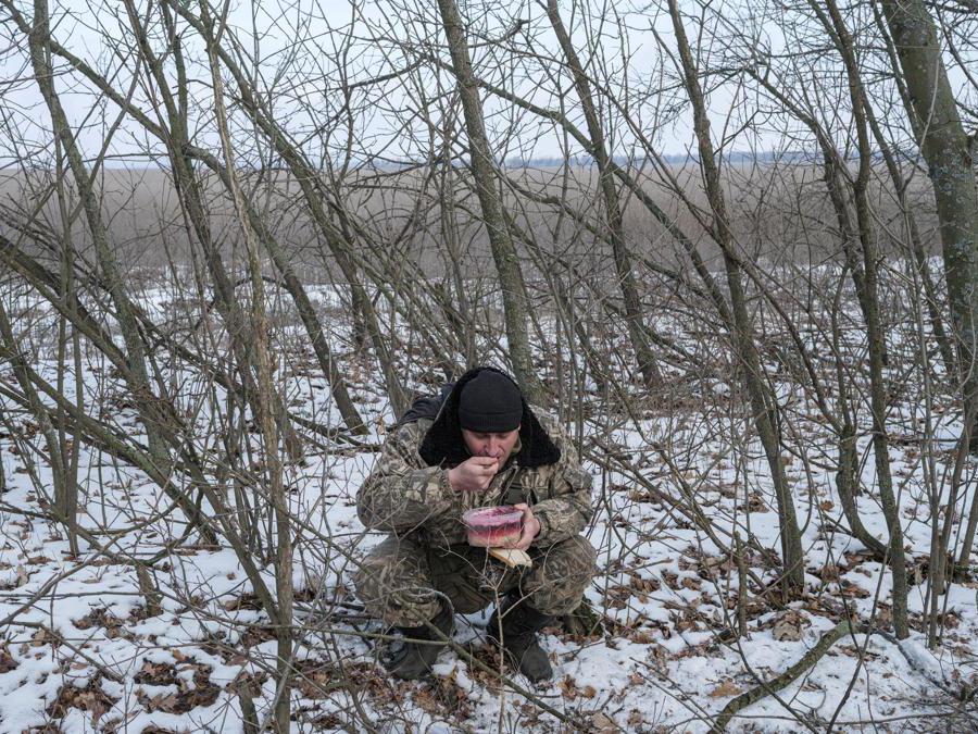 A Ukrainian army soldier from the 43rd Heavy Artillery Brigade eats, amid Russia's attack on Ukraine, near Bahmut, in Donetsk region, Ukraine, February 5, 2023. REUTERS/Marko Djurica TPX IMAGES OF THE DAY