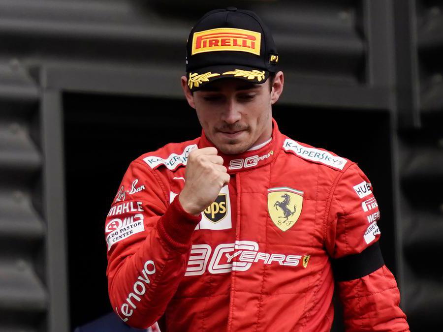 Winner Ferrari's Monegasque driver Charles Leclerc arrives to celebrate on the podium after the Belgian Formula One Grand Prix at the Spa-Francorchamps circuit in Spa on September 1, 2019. (Photo by Kenzo TRIBOUILLARD / AFP)